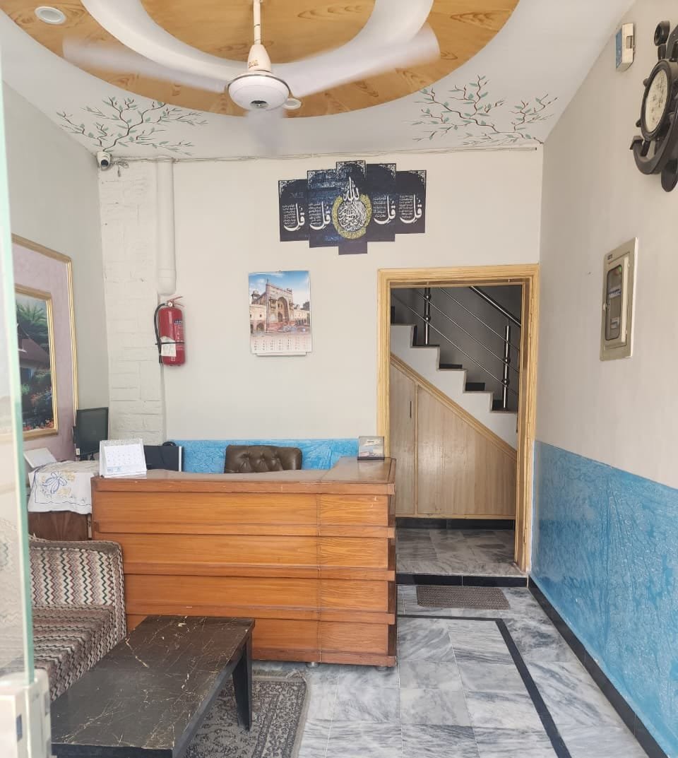Front desk and stairwell at New Palace Guest House Islamabad