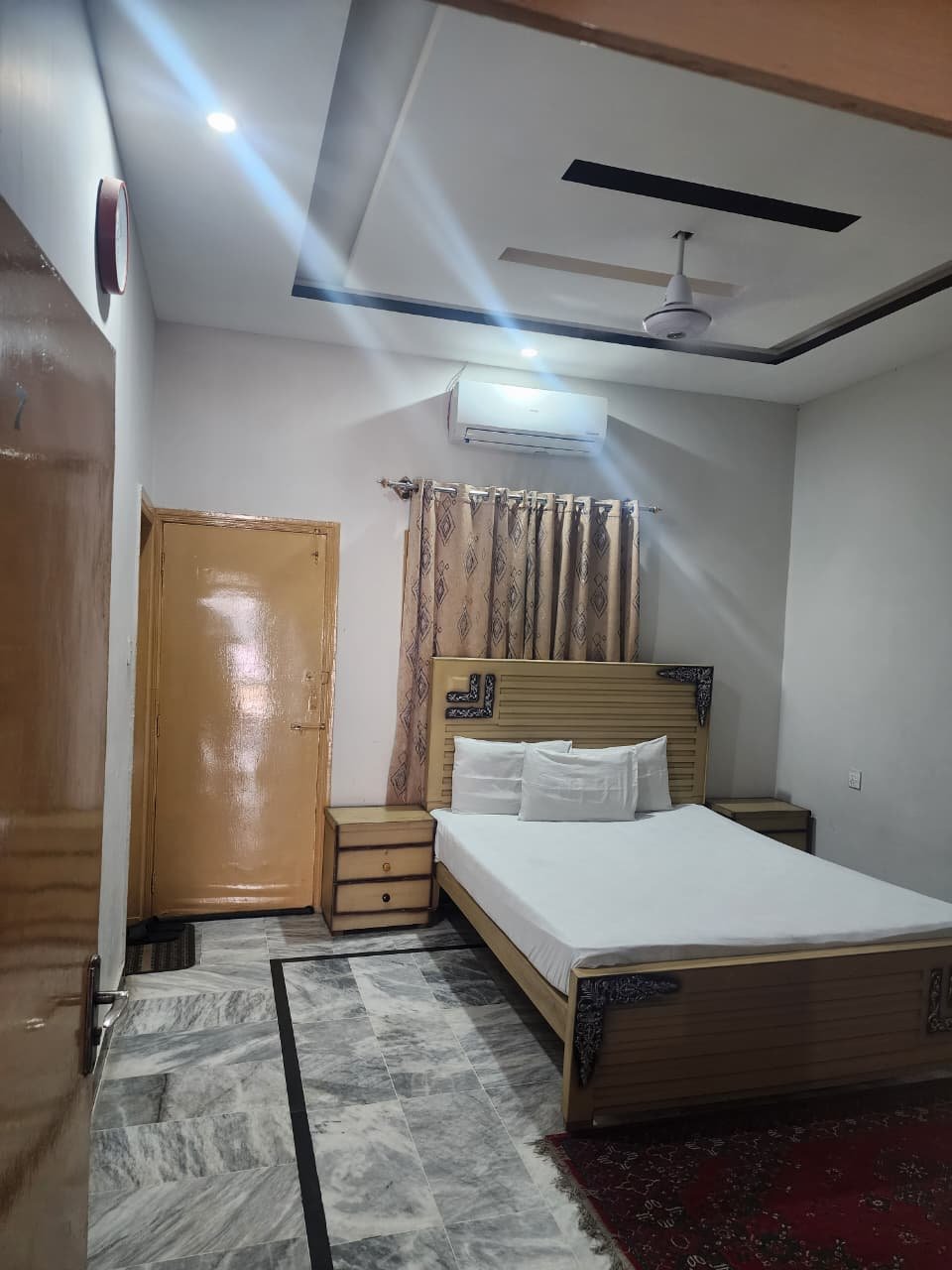 Standard Room at New Palace Guest House Islamabad with a double bed, air conditioning and marble flooring